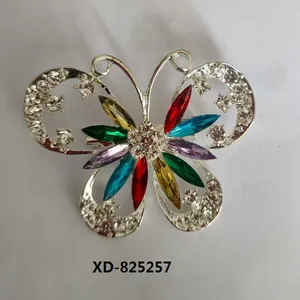 Close-up macro view of a silver-tone butterfly brooch with vibrant colorful marquise crystals