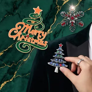 Detailed view of vintage Christmas tree and snowflake brooches on a velvet suit.