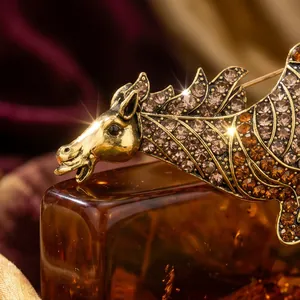 Luxury gold-toned Pegasus brooch with sparkling amber rhinestones for suits
