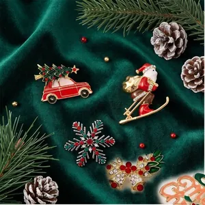 Collection of festive Christmas brooches including Santa and snowflakes on green velvet.