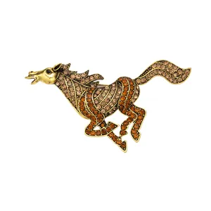 Elegant vintage gold-toned running horse brooch embellished with amber rhinestones