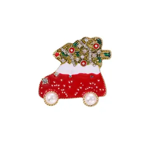 Festive Christmas car brooch with tree, rhinestones, and pearl wheels on white background.