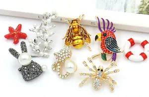 Detailed close-up showing creative animal and plant brooches with rhinestones and pearls.