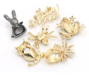 Detailed back view of creative animal and fruit brooch pins with safety clasps