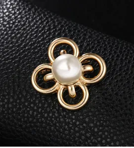 Detaillierte Makroansicht einer eleganten goldene Blumenbrosche mit einer großen weißen Perle