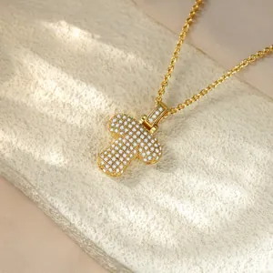 Detailed macro view of a hip hop gold iced out letter T pendant necklace with sparkling gems