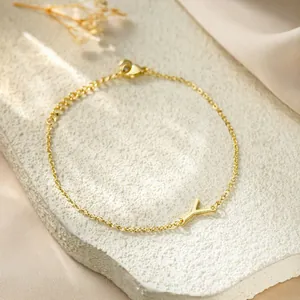 Detailed view of a gold titanium steel bracelet featuring an elegant letter Y pendant.
