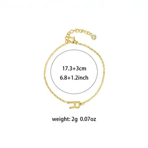 Detailed view of gold-toned titanium steel bracelet with initial R and dimensions