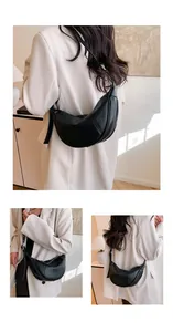 Detailansichten einer minimalistischen schwarzen Halbmond-Umhängetasche für Damen.
