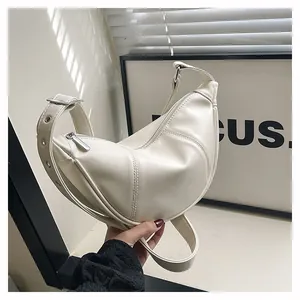 Detailansicht der minimalistischen cremeweißen Damentasche mit verstellbarem Schultergurt.