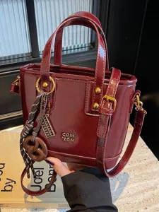 Vintage wine red patent leather handbag with gold hardware and charms