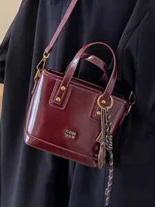Elegant burgundy faux leather bucket bag with gold hardware and top handle