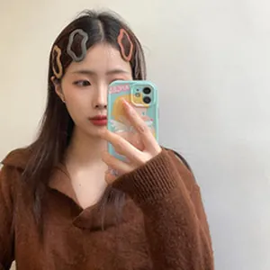 Close-up of a model wearing sweet wavy hair clips in grey and brown for autumn style