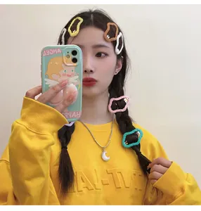 Asian model showcasing colorful hollow cloud-shaped hair clips in vibrant yellow shades