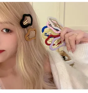 Model wearing a plush cloud-shaped hair clip and holding a colorful set of BB clips