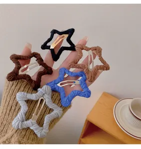 Detailed macro shot of star-shaped hair clips wrapped in colorful soft knitting yarn