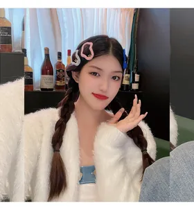Close-up of an Asian model wearing colorful fluffy cloud hollow-out hair clips for winter