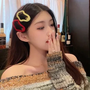 Stylish wavy cloud-shaped hair clips worn by a model for autumn winter fashion hair styling.