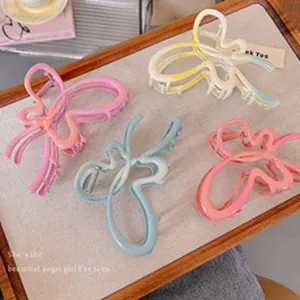 Close-up detail view of colorful butterfly hair claws on a fabric textured display tray
