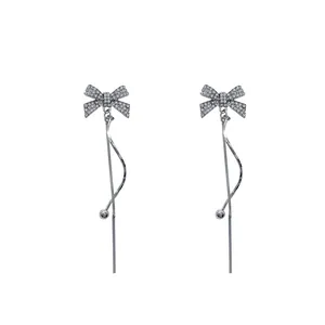 Elegant sparkling zircon bow earrings with long winding tassel design in silver finish.