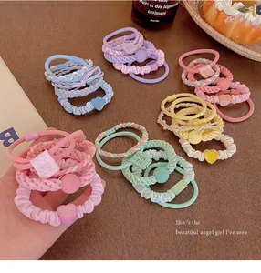 Detailed view of colorful dopamine hair ties with sweet heart and pearl charms