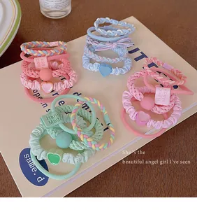 Detail showing variety of colorful dopamine style ruffled and braided hair scrunchies