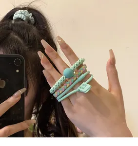 Detailed view of mint green dopamine hair ties worn on hand for showcase
