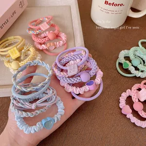 Set of colorful pastel elastic hair ties featuring cute heart charms and textured beads