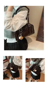 Elegant large capacity dark brown glossy underarm shoulder bag worn by model in cafe setting