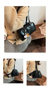 Detail shots of black glossy large capacity underarm shoulder bag with sports charm