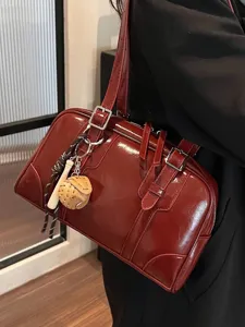 Elegant burgundy glossy shoulder bag with charms for women, large capacity tote.