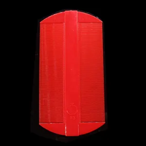 Detailed close-up view of red double-sided fine-toothed plastic nit comb for lice removal