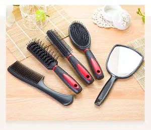 Detailed top-down view of a five-piece professional hair brush and mirror grooming set