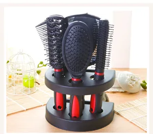 Close-up of a 5-piece professional hairbrush and mirror set in a black storage stand