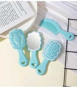 Detailed macro view of the light blue cloud-shaped hair brush and mirror set for girls