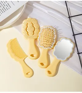 Detailed close-up view of the yellow cloud-shaped hairbrush and hand mirror set