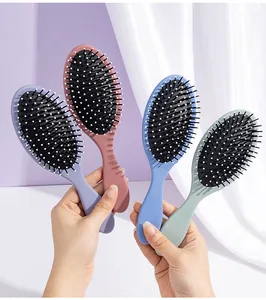 Four Morandi color oval cushion hair brushes shown together for scalp massage detail