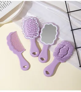 Detailed view of lavender cloud-shaped hairbrushes and handheld mirror grooming set