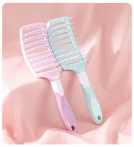 Rib-style vented hair brushes in pink and mint green displayed on soft pink draped silk