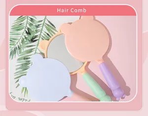 Close-up of cute cat-ear handheld mirrors in pastel pink and blue colors