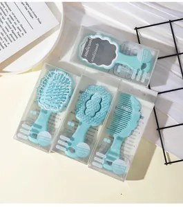 Detailed macro view of light blue cloud-shaped hairbrush and mirror set in retail packaging