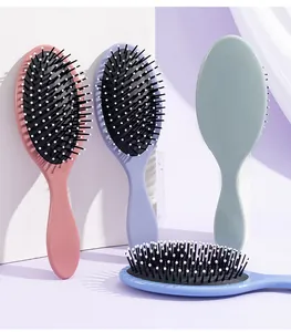 Detail of Morandi colored oval air cushion hairbrushes in pink, purple, green, and blue