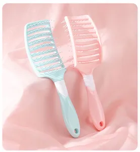 Professional curved vented hair brushes in pastel pink and blue for hair styling and massage