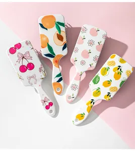 Group of four cute fruit pattern air cushion hairbrushes with colorful prints