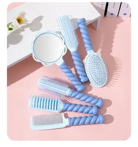 Close-up of pastel blue hairbrush and mirror set with twisted handles