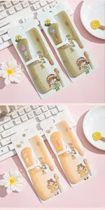 Close-up detail of cartoon hair comb sets in khaki and orange with cute character prints.