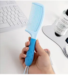 Détail du peigne à cheveux bleu avec motif de patte de chat mignon sur la poignée