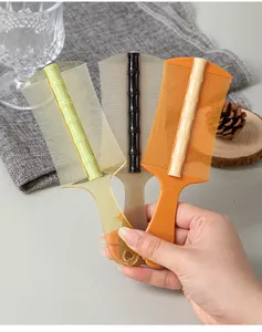 Detailed view of three bamboo-style handle fine-tooth nit combs in various colors.