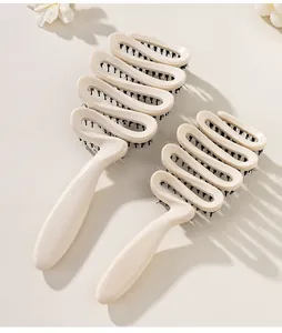 Detailed close-up showing the unique hollow ribbon design and boar bristles of hairbrushes