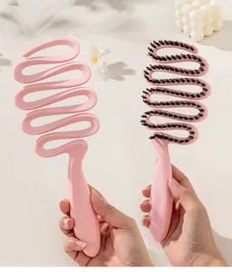 Detailed view of the pink hollow boar bristle hair brush for styling and detangling